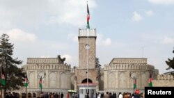 People walk outside the presidential palace before Afghanistan's President Ashraf Ghani's oath, during his inauguration as president in Kabul, March 9, 2020.