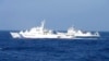 Chinese marine surveillance ship Haijian No. 51 (R) cruises next to a Japan Coast Guard patrol ship, Akaishi, in the East China Sea near the disputed isles known as Senkaku isles in Japan and Diaoyu islands in China, Feb. 4, 2013.
