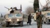 FILE - Afghan National Army soldiers inspect the site of a car bomb attack on a military base in Shirzad district of Nangarhar province, Afghanistan, Jan. 30, 2021. 