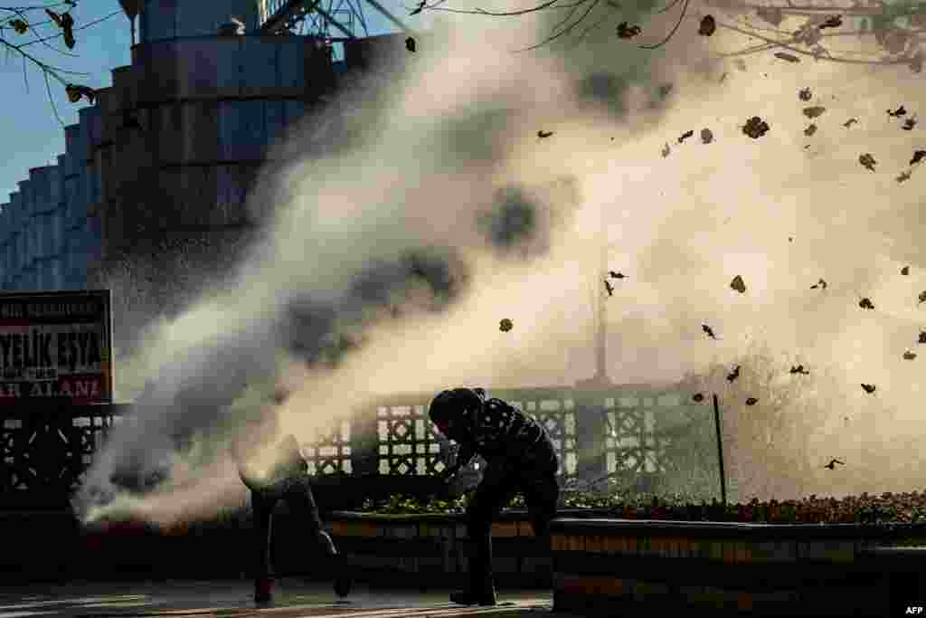 Turkish riot police use a water cannon to disperse protesters from Diyarbakir&#39;s historical Sur district which has been placed under a curfew, in Diyarbakir. More than a week after prominent Kurdish lawyer Tahir Elci was killed in broad daylight in a street in southeastern Turkey&#39;s main city, authorities appear no closer to solving the crime amid bitter recriminations over who was to blame.