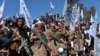 Afghan Taliban militants and villagers attend a gathering as they celebrate the peace deal in the Afghan conflict with the U.S. in Afghanistan, in Alingar district of Laghman Province on March 2, 2020. 