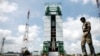 A paramilitary soldier walks past the Polar Satellite Launch Vehicle (PSLV-C25) at the Satish Dhawan Space Center at Sriharikota, in the southern Indian state of Andhra Pradesh, Oct. 30, 2013. 