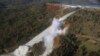 A Feb. 11, 2017, aerial photo released by the California Department of Water Resources shows a damaged spillway with an eroded hillside in Oroville, California.