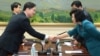 In this photo released by the South Korean Unification Ministry, South Korea's Unification Policy Officer Chun Hae-sung, left, shakes hands with the head of North Korea's delegation Kim Song Hye, right, after ending their meeting at the southern side of P