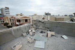 FILE - A damaged roof is seen after a barrage of rockets hit in and near Erbil International Airport, in Erbil, Iraq, Feb. 16, 2021.