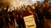 Demonstrators shout slogans during candlelight vigil marking first anniversary of deadly gang rape, New Delhi, Dec. 16, 2013.