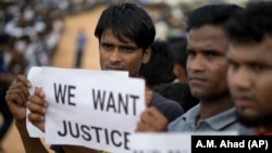 Rohingya refugees holding placards, await the arrival of a U.N. Security Council team at the Kutupalong Rohingya refugee camp in Kutupalong, Bangladesh, on April 29, 2018.