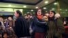 Supporters of Turkish rights defender Osman Kavala react after Istanbul prosecutors issued a new arrest warrant for him, as part of a separate probe following his acquittal earlier in the day, in Silivri, near Istanbul, Feb. 18, 2020.