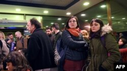 Supporters of Turkish rights defender Osman Kavala react after Istanbul prosecutors issued a new arrest warrant for him, as part of a separate probe following his acquittal earlier in the day, in Silivri, near Istanbul, Feb. 18, 2020.