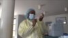 A health official at Wilkins Hospital in Harare, Zimbabwe, prepares to inoculate with Sinopharm vaccine, March 11, 2021. (Columbus Mavhunga/VOA)