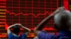 Investors monitor a display showing the Shanghai Composite Index at a brokerage in Beijing, Aug. 31, 2015. 