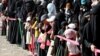 Women and girls queue for Iftar (breaking of fast) meals supplied by a local charity during the holy month of Ramadan in Sana'a, Yemen June 12, 2016. 