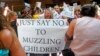 FILE - People celebrate after the Salt Lake County Council voted in Salt Lake City, Utah, to overturn a school mask order for kids under the age of 12 issued by the county’s top health official, Aug. 12, 2021.