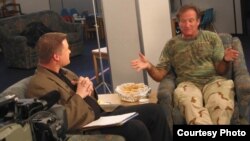 Then-American Forces Network reporter Kane Farabaugh interviews Robin Williams in Afghanistan in 2002.
