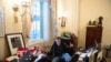 Richard Barnett, a supporter of President Donald Trump sits inside the office of US Speaker of the House Nancy Pelosi as he protests inside the U.S. Capitol in Washington, D.C., Jan. 6, 2021.