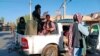 FILE - Taliban fighters patrol inside the city of Farah, capital of Farah province southwest of Kabul, Afghanistan, Aug. 11, 2021. 