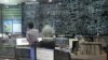 An employee of the Korea Power Exchange, a state company to check the country's flow of electricity, watches a huge screen monitoring power supply during power outages in Seoul, September 15, 2011. 