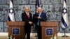 Israeli President Reuven Rivlin gives Israeli Prime Minister Benjamin Netanyahu a file during a nomination ceremony at the President's residence in Jerusalem, Sept. 25, 2019. 