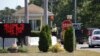 Vehicles are stopped by security personal as they enter a gate to Camp Edwards, Massachusetts, on Cape Cod, Sept. 22, 2014. Police and military officials were searching Monday for three soldiers from the Afghanistan National Army who went missing Saturday.