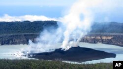 This Sunday, Oct. 1, 2017 photo provided by GeoHazards Divison, Vanuatu Meteorological and GeoHazards Department, shows an aerial view of the volcanic cone that has formed in Lake Vui near the summit of Ambae Island, Vanuatu.