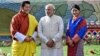 Visiting Indian Prime Minister Narendra Modi, stands with Bhutan's King Jigme Khesar Namgyel Wangchuck, left and Queen Jetsun Pema, right, during a ceremonial reception at Royal Palace in Thimphu, Bhutan, June 15, 2014. 