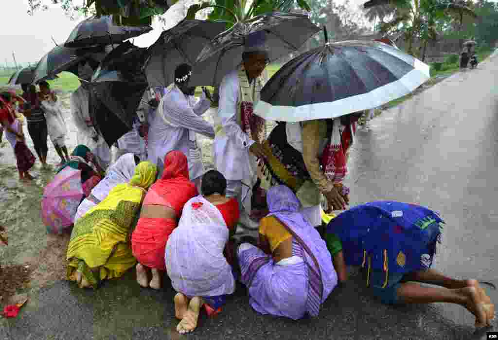 Indian women seek blessings from the Mayong &#39;Kings&#39; as they take part in the age-old, traditional &#39;Gohain Uliuwa Mela&#39; festival in Mayong village, in the Morigaon district of Assam state.