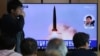 People watch a TV showing a news program reporting North Korea's missile launch, at the Seoul Railway Station in Seoul, South Korea, May 5, 2019.