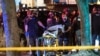 FILE - Police officers help remove the body of a man who was shot dead amid weekend street clashes between supporters of President Donald Trump and counterdemonstrators in Portland, Oregon, Aug. 29, 2020. 