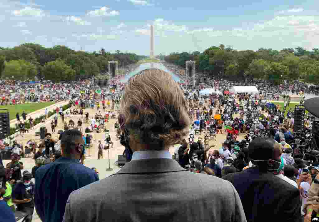 Rev. Al Sharpton, center, whose National Action Network organized the &quot;Commitment March: Get Your Knee Off Our Necks&quot; protest against racism and police brutality, arrives at the Lincoln Memorial in Washington, D.C. 