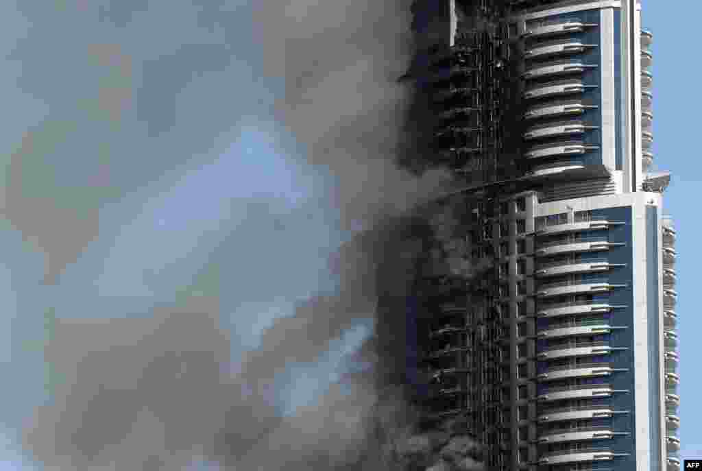 Smoke billows from the Address Downtown Hotel in Dubai in the aftermath of a huge fire that engulfed several floors of the building. The fire ripped through the luxury Dubai hotel late on Dec. 31, 2015.