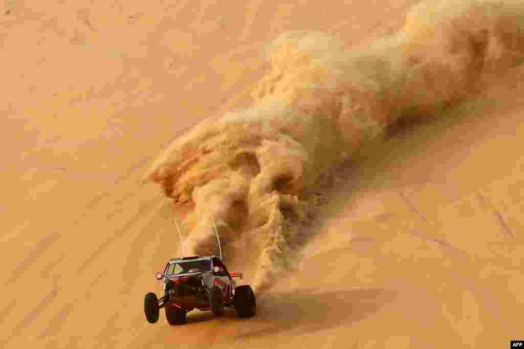 A dune buggy driver trains before competing in a drag racing event, as part of the Liwa 2016 Moreeb Dune Festival in the Liwa desert, some 250 kilometers southwest of Abu Dhabi. The festival, which attracts participants from around the Gulf region, includes a variety of races (cars, bikes, falcons, camels and horses) or other activities aimed at promoting the country&#39;s folklore.