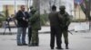 Armed men check journalists documents around the regional parliament building in the Crimean city of Simferopol March 1, 2014.