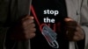 FILE - A man’s T-shirt reads “Stop the Cut,” a reference to female genital mutilation, during a social event advocating against such harmful practices at the Imbirikani Girls High School in Imbirikani, Kenya, April 21, 2016.