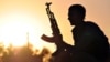 A fighter from the Kurdish People Protection Unit (YPG) is photographed at sunset in the Syrian town of Ain Issi, north of Raqqa during clashes between IS jihadists and YPG fighters, July 10, 2015. 