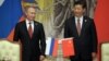 Russia's President Vladimir Putin, and China's President Xi Jinping, right, smile during signing ceremony in Shanghai, China on May 21, 2014.