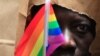 An asylum seeker from Uganda covers his face with a paper bag in order to protect his identity as he marches with the LGBT Asylum Support Task Force during the Gay Pride Parade in Boston, Massachusetts June 8, 2013. 