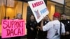 FILE - A supporter of President Donald Trump challenges police officers and a Deferred Action for Childhood Arrivals (DACA) program advocate during a rally outside the office of California Democratic Sen. Dianne Feinstein in Los Angeles, California, Jan. 