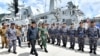 FILE - Indonesian President Joko Widodo, center, inspect troops during his visit at Indonesian Navy ship KRI Usman Harun at Selat Lampa Port, Natuna Islands, Indonesia, Wednesday, Jan. 8, 2020. 
