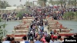 Displaced Sunni people, who fled the violence in the city of Ramadi, arrive at the outskirts of Baghdad, Iraq, April 17, 2015.