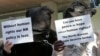 Former North Korean defectors, who have been living in South Korea since their escape from the North, hold signs during a rally in Seoul, Nov. 2009.