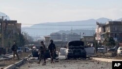 Afghan security personnel gather at the site of an explosion in Kabul, Afghanistan, Nov. 13, 2019. An explosion rocked the Afghan capital as early morning commuters were on the street heading to work.