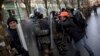 A photographer takes photos of an opposition supporter during a march toward parliament in Kyiv, Ukraine, Feb. 6, 2014.