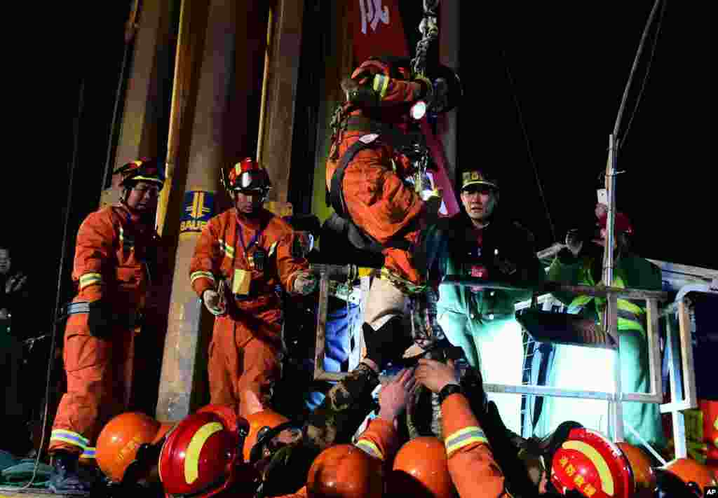 The first miner, is lifted from a collapsed mine in Pingyi, east China&#39;s Shandong Province. Chinese state media say two miners have been rescued from a collapsed mine after spending 36 days trapped underground. The gypsum mine collapsed on Christmas Day, killing one and leaving 13 others missing.
