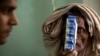 A tuberculosis patient holds medicines at the Lal Bahadur Shastri Government Hospital at Ram Nagar in Varanasi, India, March 13, 2018.