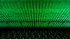 FILE - A computer keyboard lit by a displayed cyber code is seen in this illustration picture taken on March 1, 2017. 