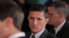 FILE - Then-White House National Security Adviser Michael Flynn, center, arrives at the White House in Washington, Feb. 13, 2017.