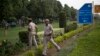 Indian policemen secure the area outside the Pakistan High Commission as Kashmiri separatist leaders arrive for talks with the Pakistani high commissioner in New Delhi, India, Aug. 19, 2014. 