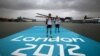 Rower Oksana Masters and her rowing partner, Rob Jones from the United States, carry their oars after a training session ahead of the 2012 Paralympics Olympics in Eton Dorney, near Windsor, England, August 29, 2012.