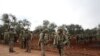 Turkish soldiers gather in the village of Qaminas, about 6 kilometers southeast of Idlib city in northwestern Syria, Feb. 10, 2020. 