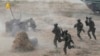 FILE - Soldiers rush after alighting from an assault amphibious vehicle during a military drill in Kaohsiung City, Taiwan, Jan. 12, 2023. Taiwan's annual war games this year will be as close as possible to actual combat.